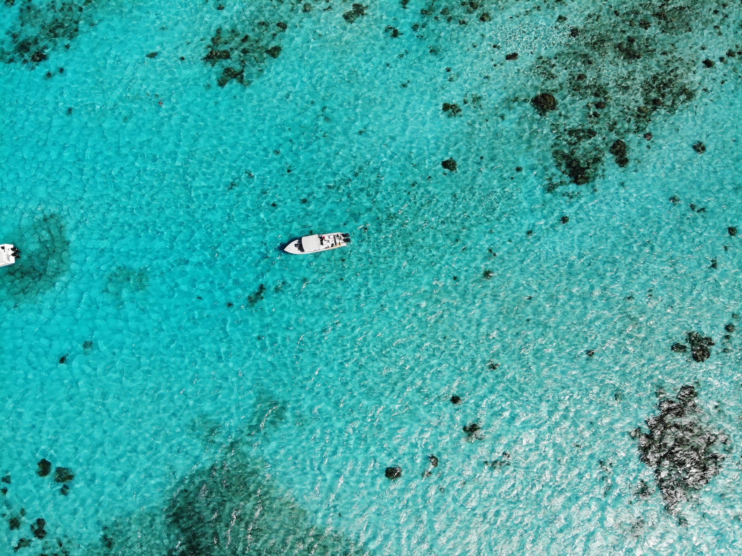 Aerial view of a boat on the turquoise waters of the Belize Barrier Reef